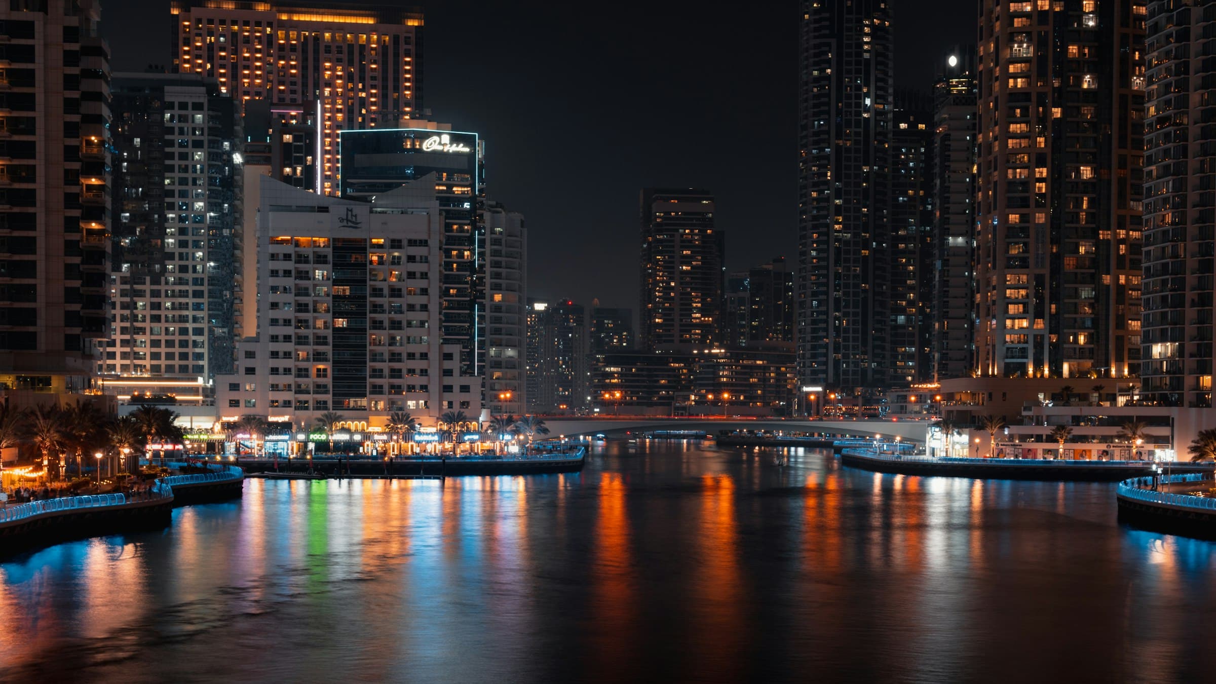 Dubai Marina towers reflected in the water at night